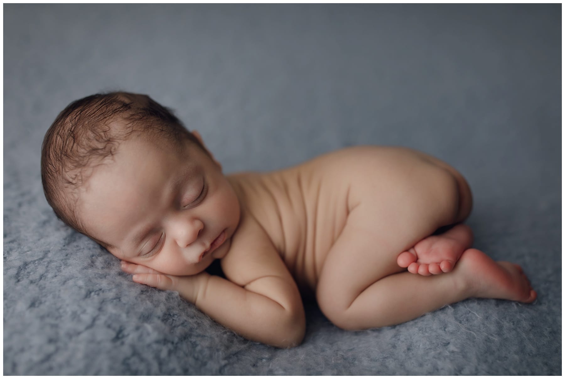 Newborn baby boy sleeping on blue blanket during photo session with 8.08 Photography in Jacksonville Fl