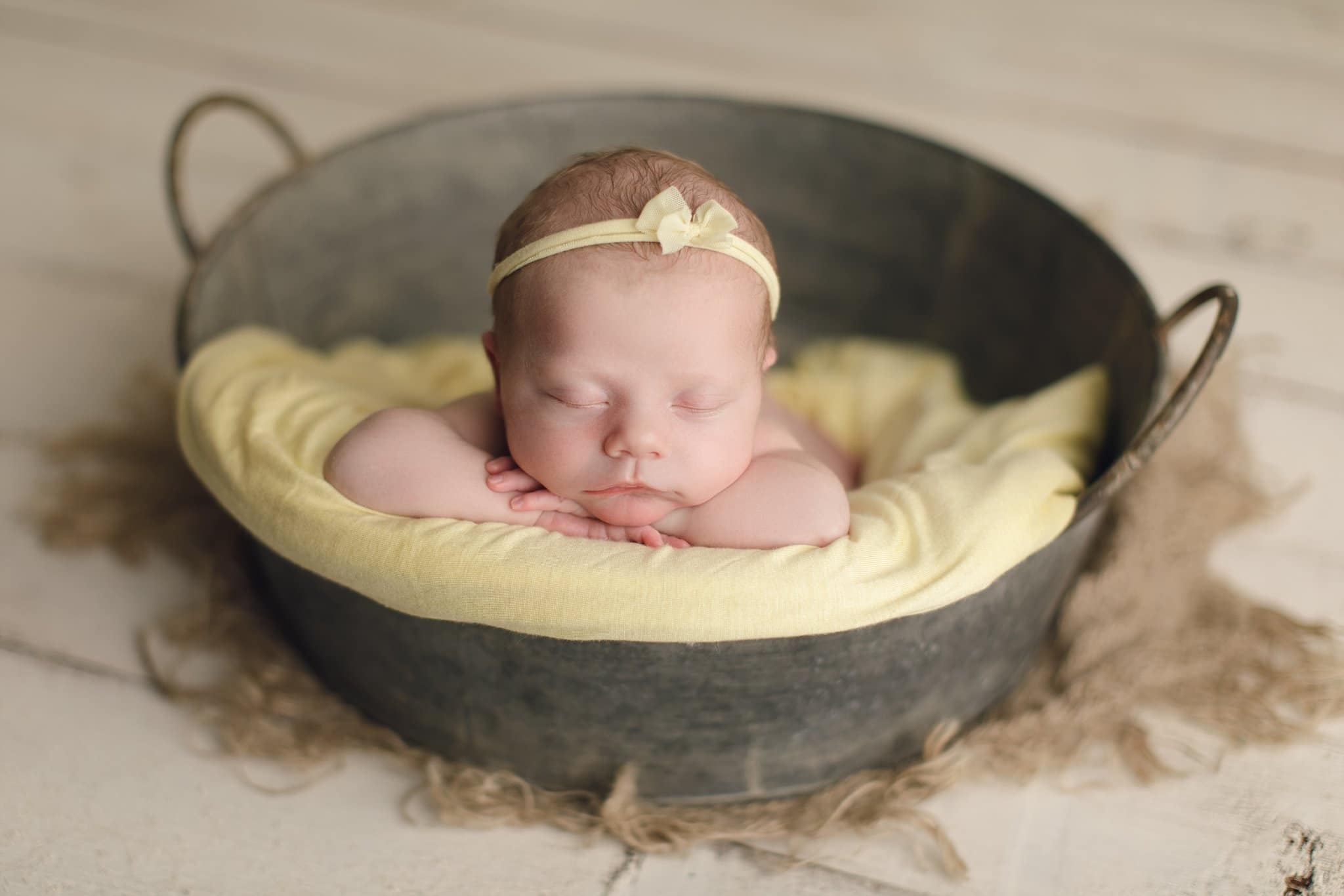 Custom Newborn Portraiture Jacksonville Fl newborn photo session. sleeping baby with simple headband yellow bow and wrap