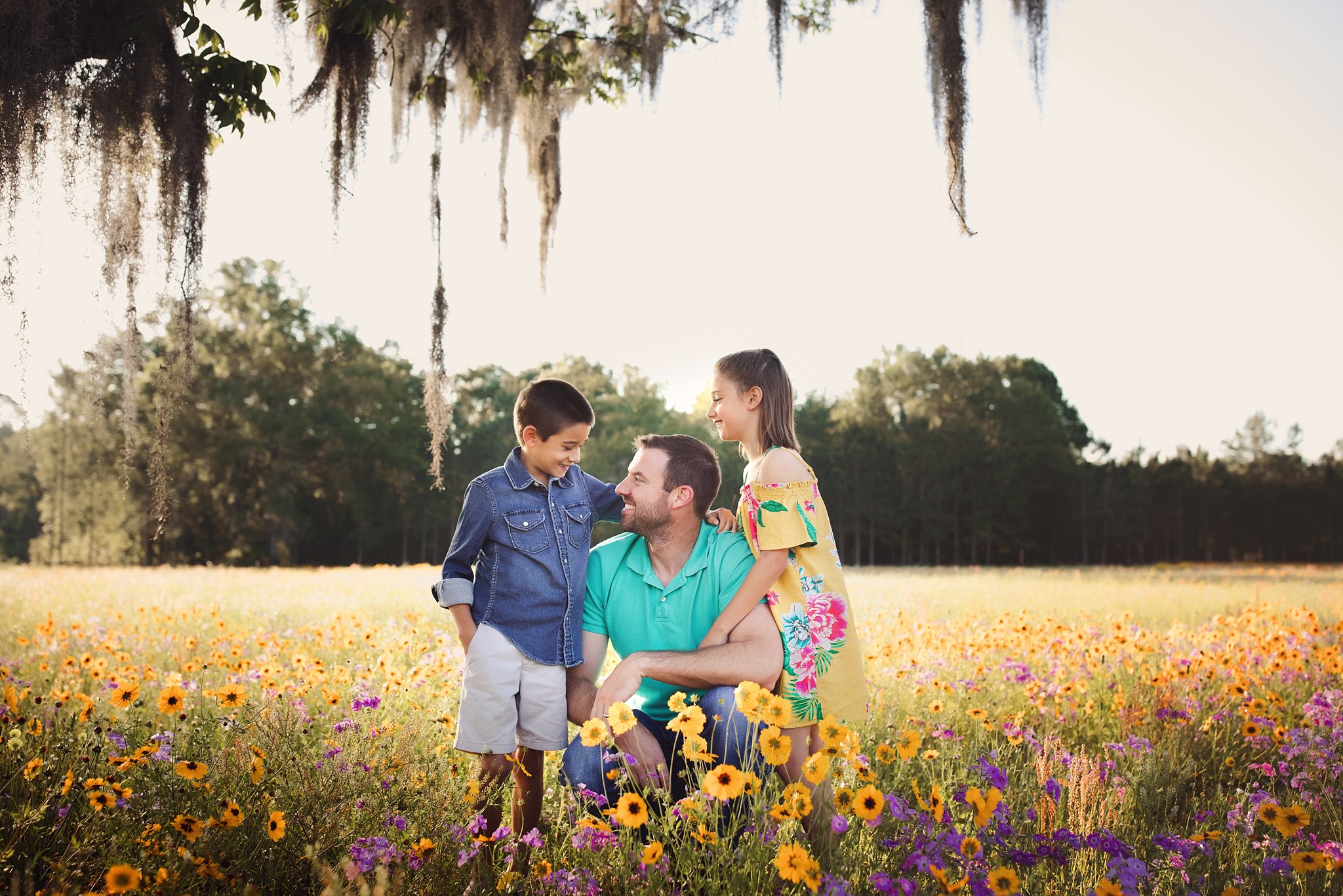 Flower Field Photos in Jacksonville dad with 2 children in flower field at sunrise