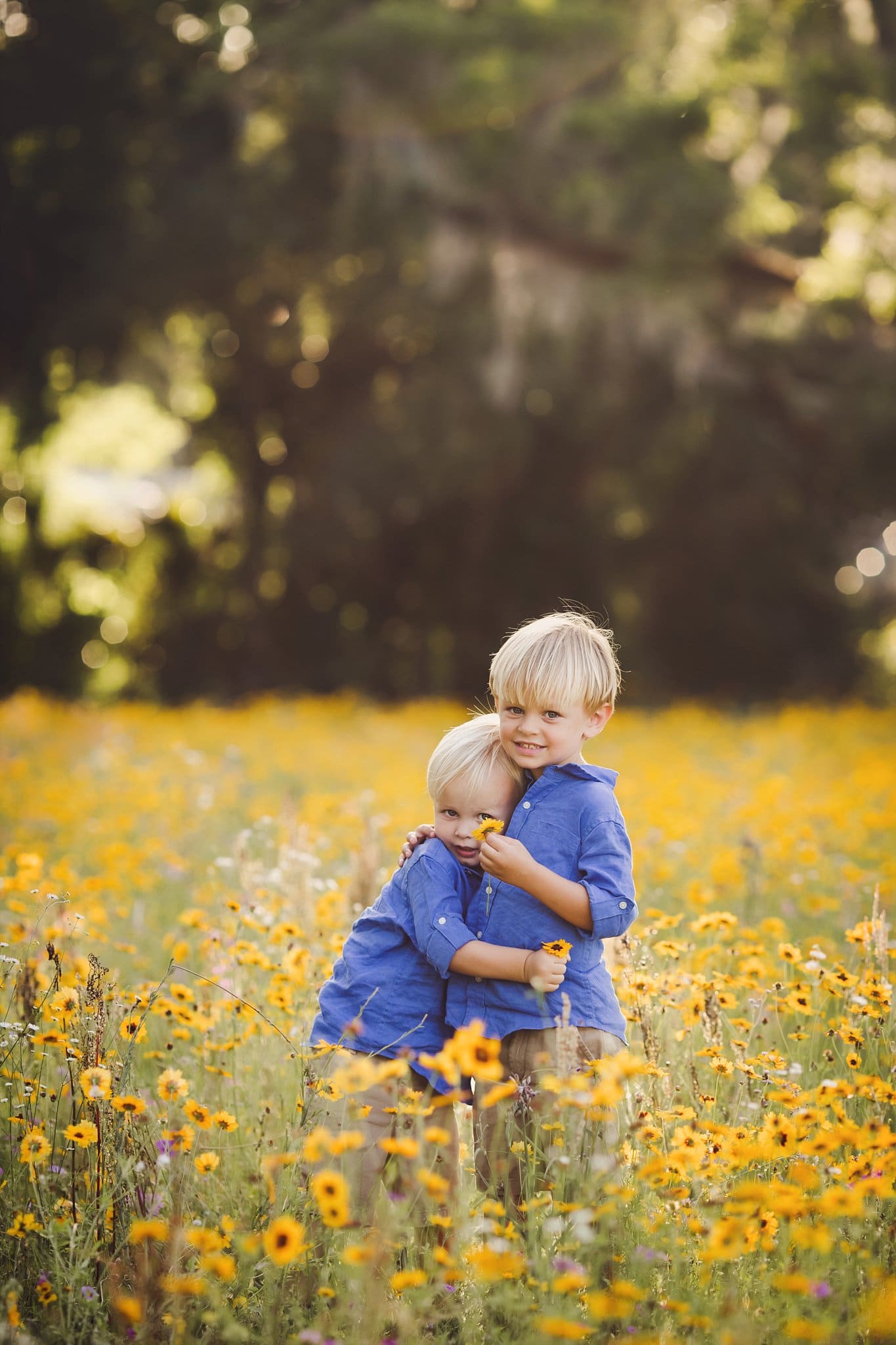 NE FL Family Photography brothers running through yellow flower field