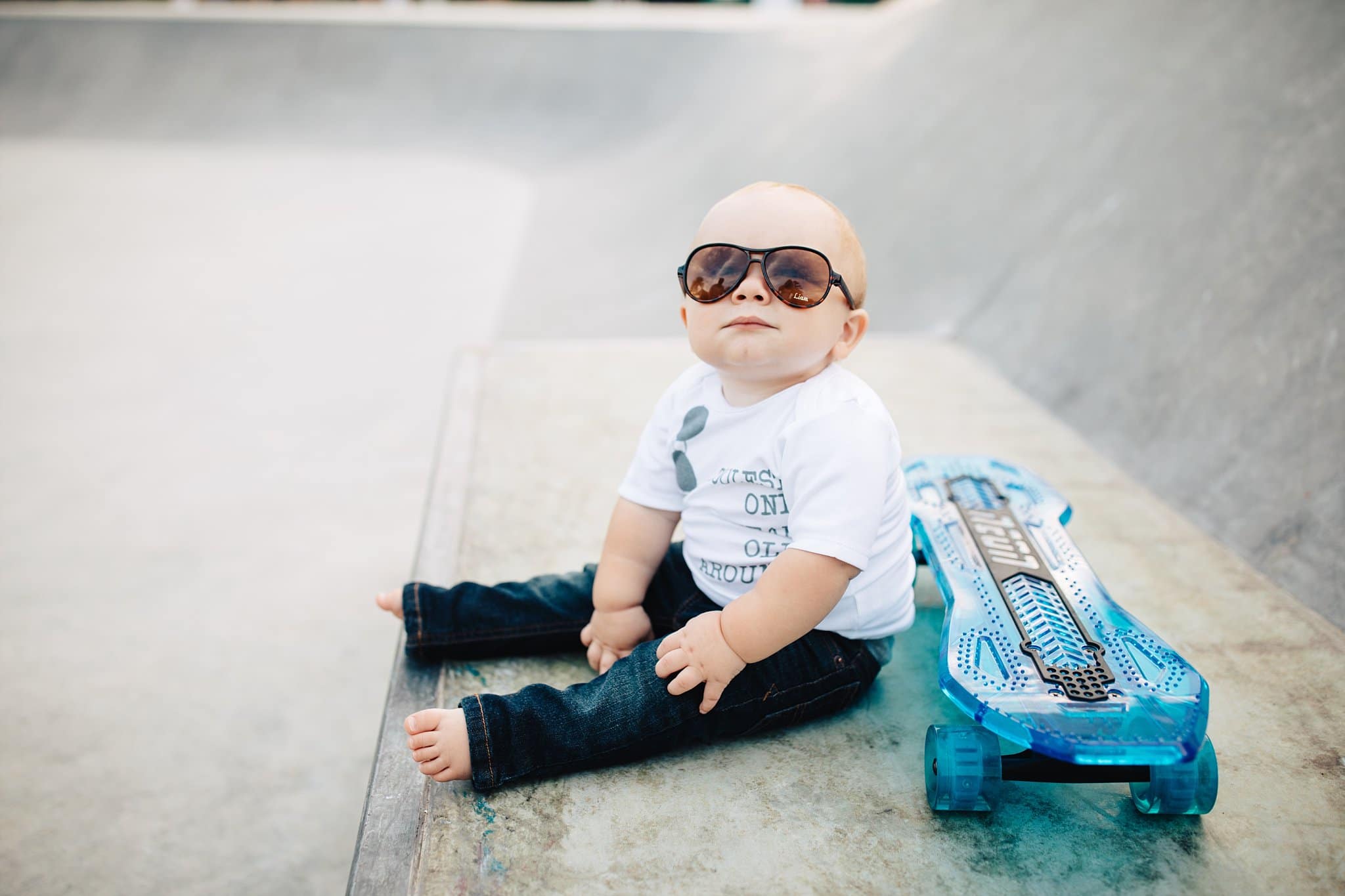 One Year Photos in Jacksonville toddler baby with skateboard ray bans at skate park sunshine park 