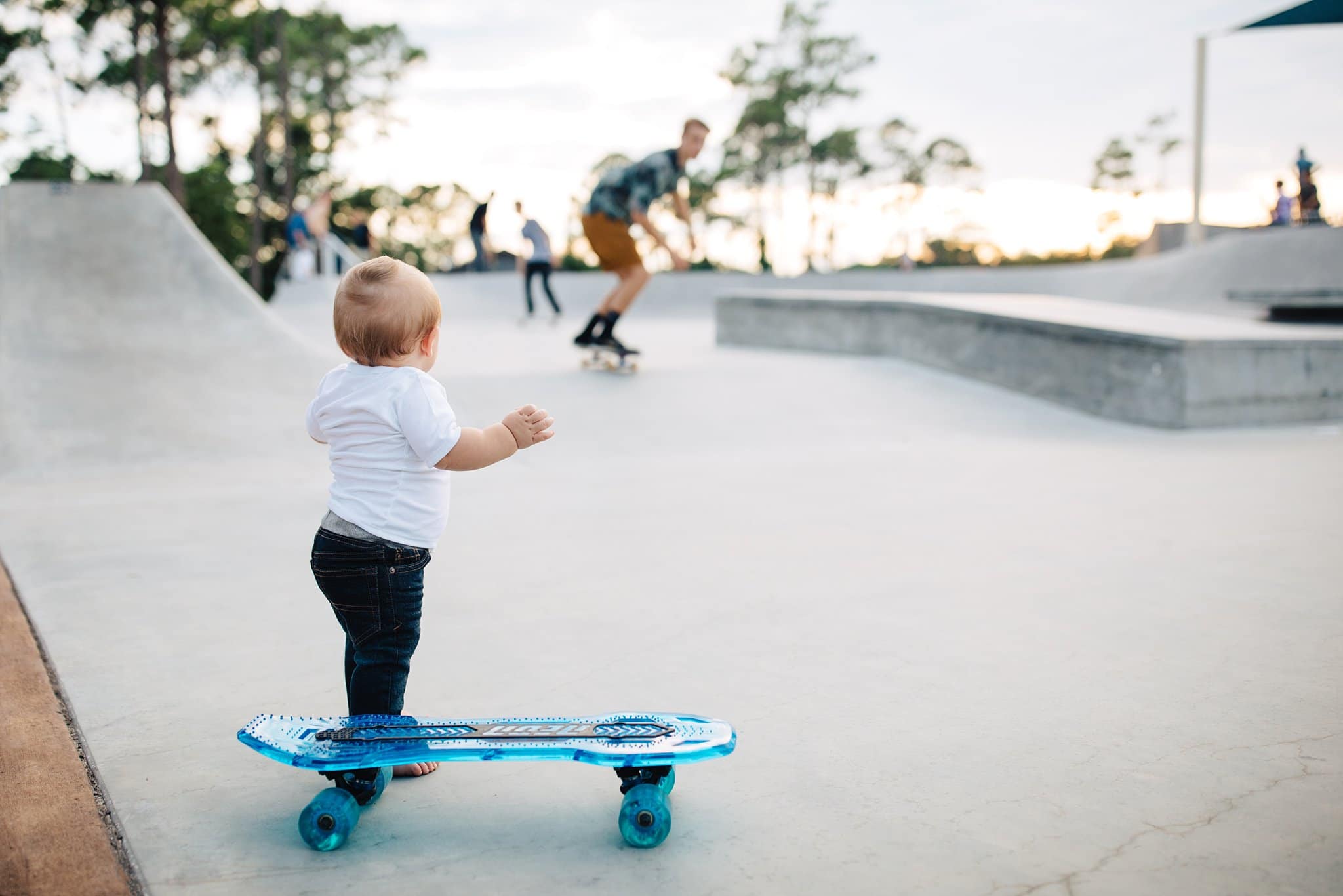 One Year Photos in Jacksonville toddler baby with skateboard ray bans at skate park sunshine park