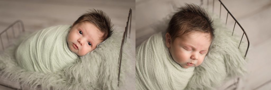 Newborn baby boy swaddled in mint green on little bed eye contact fuzzy mattress