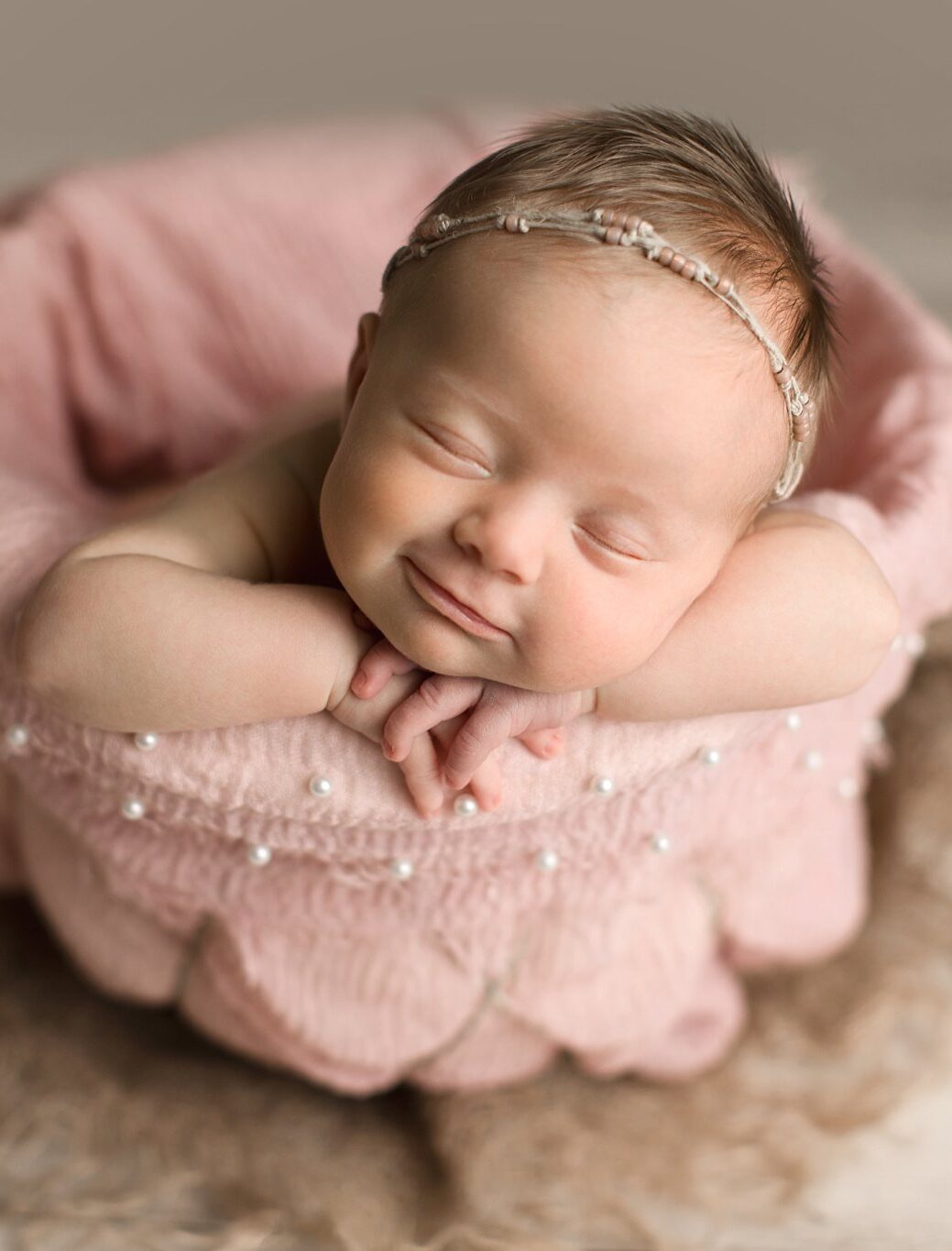 newborn baby girl forward Baby Photographer in Jacksonville facing in basket smiling hello little props pink pearl layer
