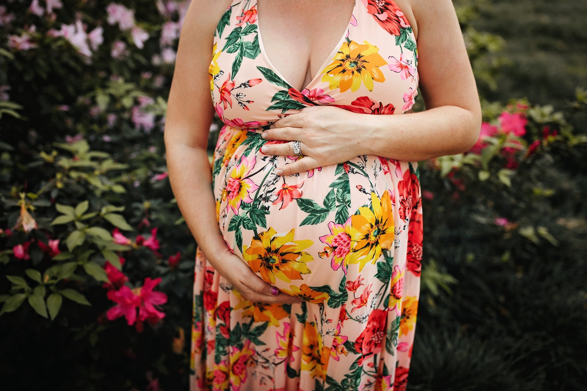 St Augustine Maternity Photographer Washington Oaks Gardens State Park pregnant belly with mom's hands on floral dress