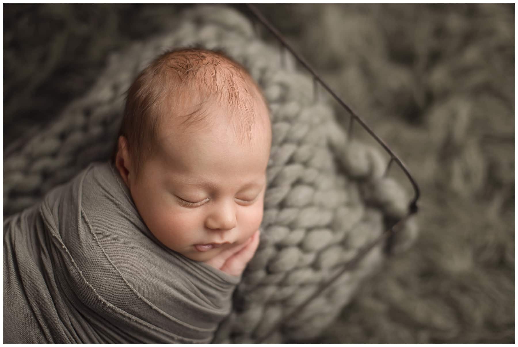 6 week old boy sleeping on sage green thick knit blanket