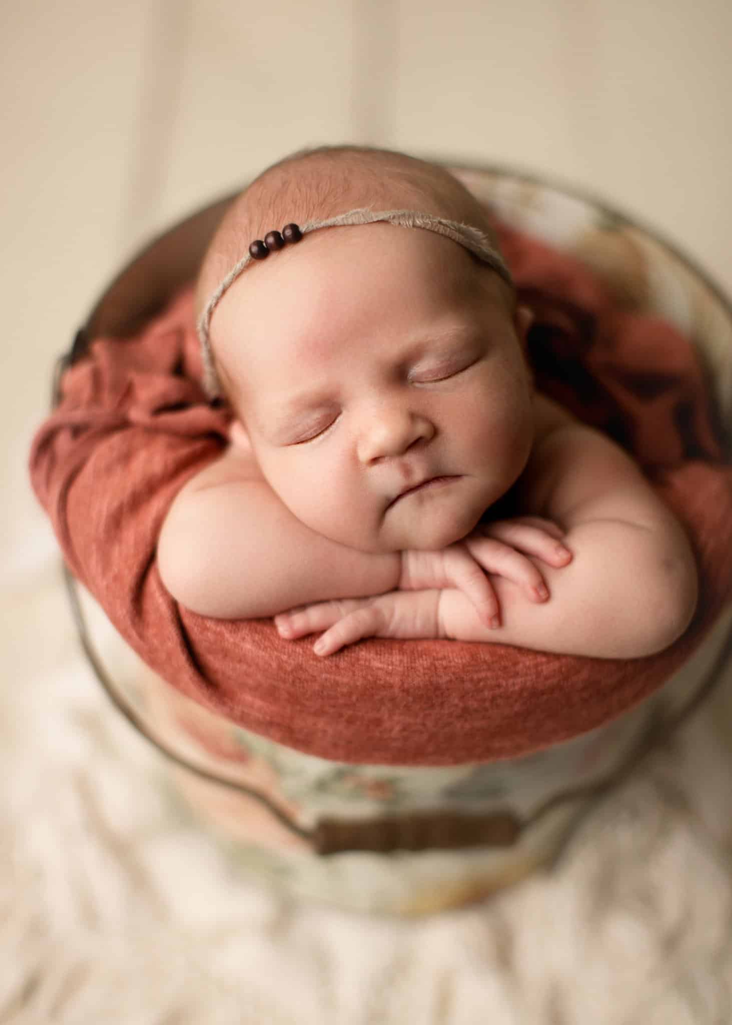 boho newborn baby in a bucket with beaded headband