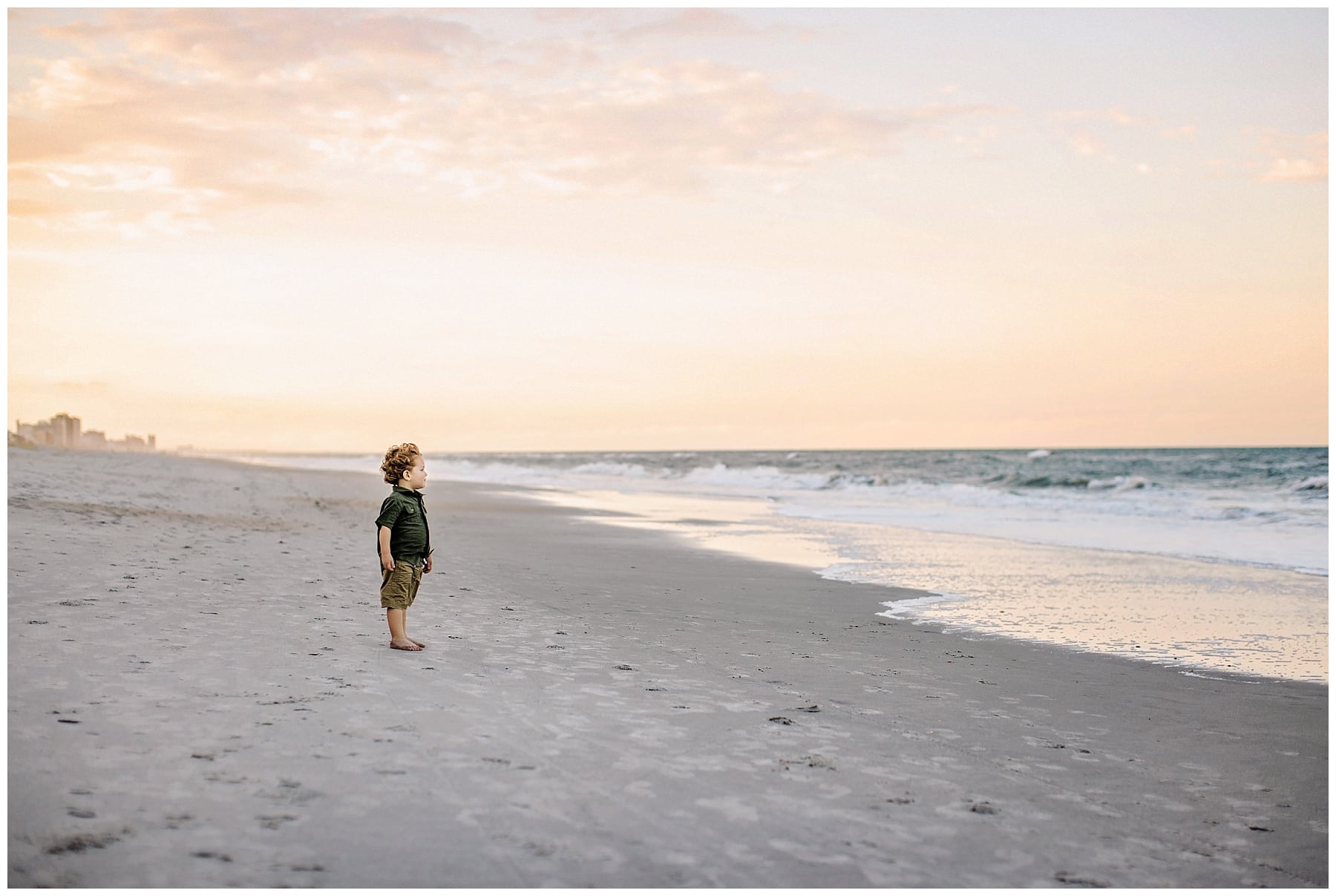 toddler photos at ponte vedre beach looking at ocean at sunset