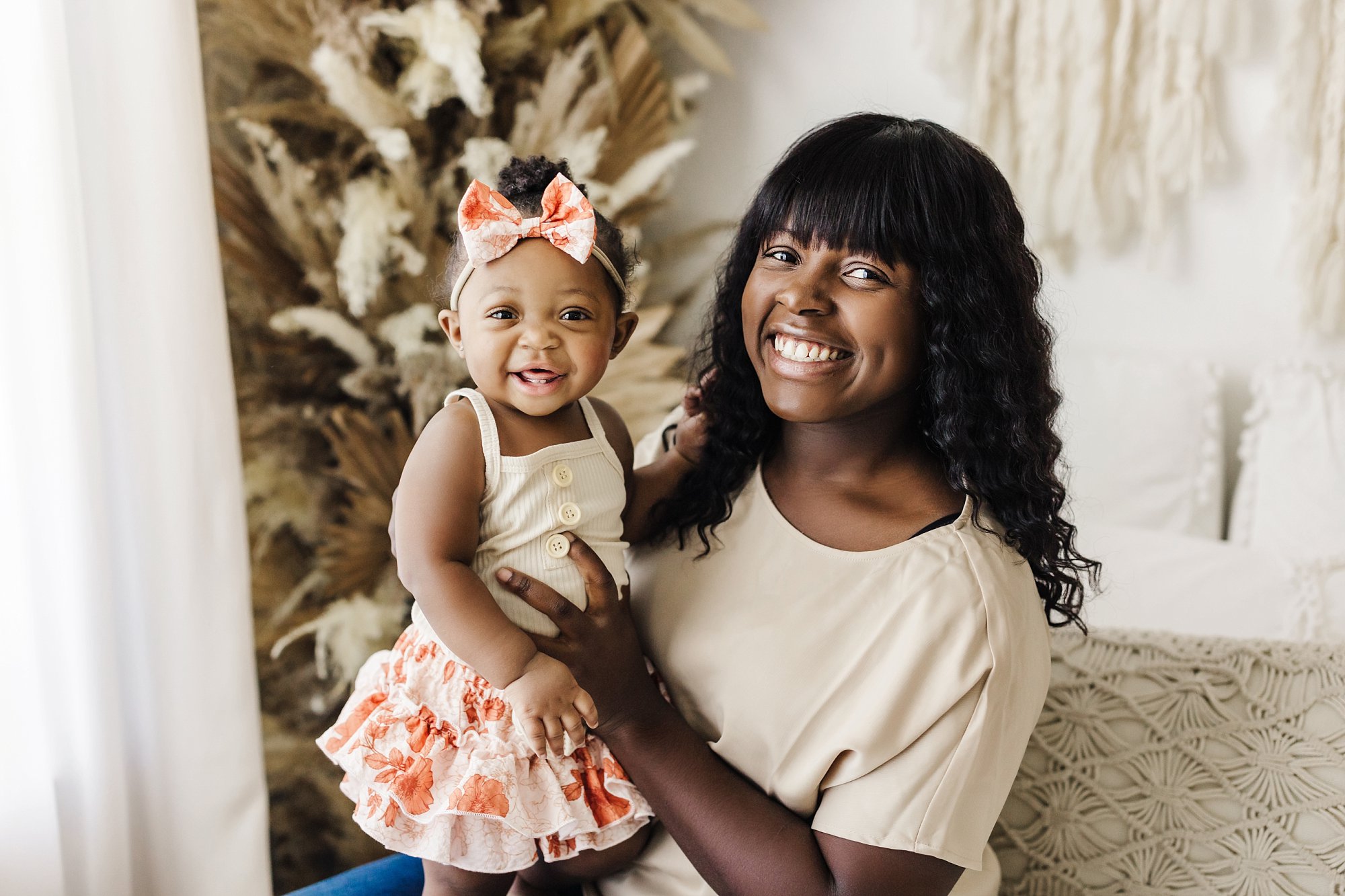 portrait of mom and one year old daughter wearing neutral colors