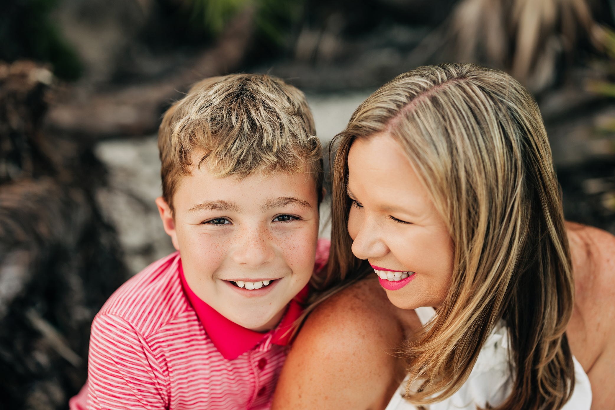 Mother laughing with her younger son during a family portrait session
